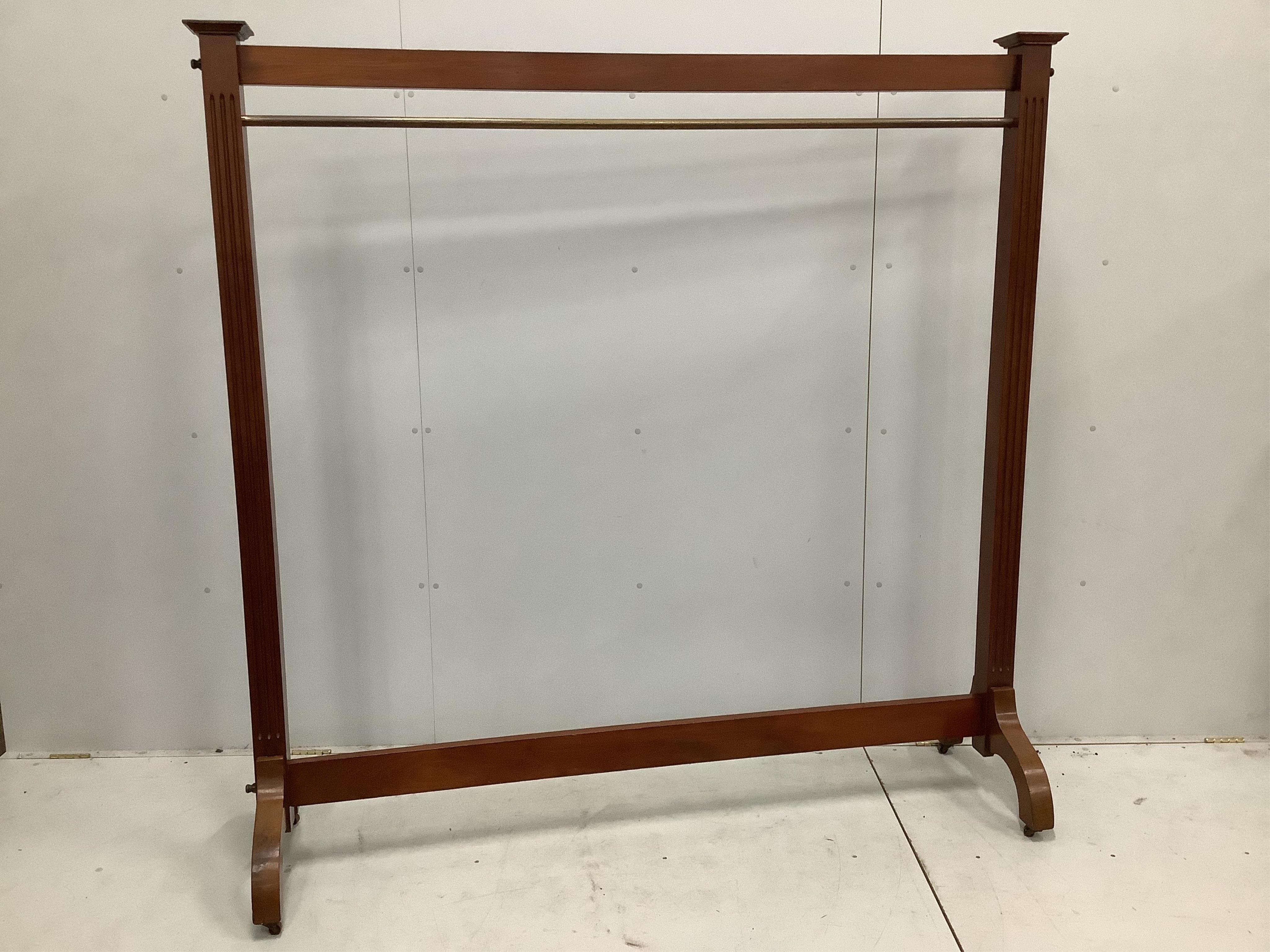 A mahogany dress rack, with reeded uprights, ex Liberty’s, width 182cm, height 184cm. Condition - fair